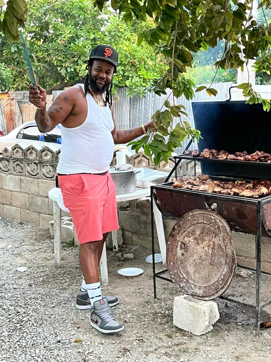 Garet tending chicken on an outdoor grill